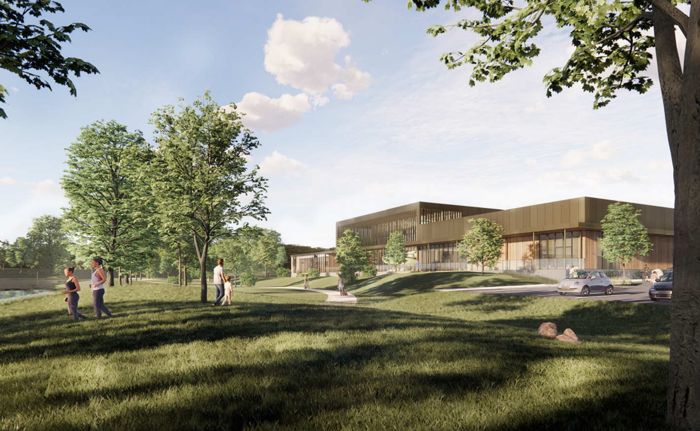 Visualiseringen viser Næstved Svømmehal set ude fra med kuperet terræn og græs i forgrunden. 